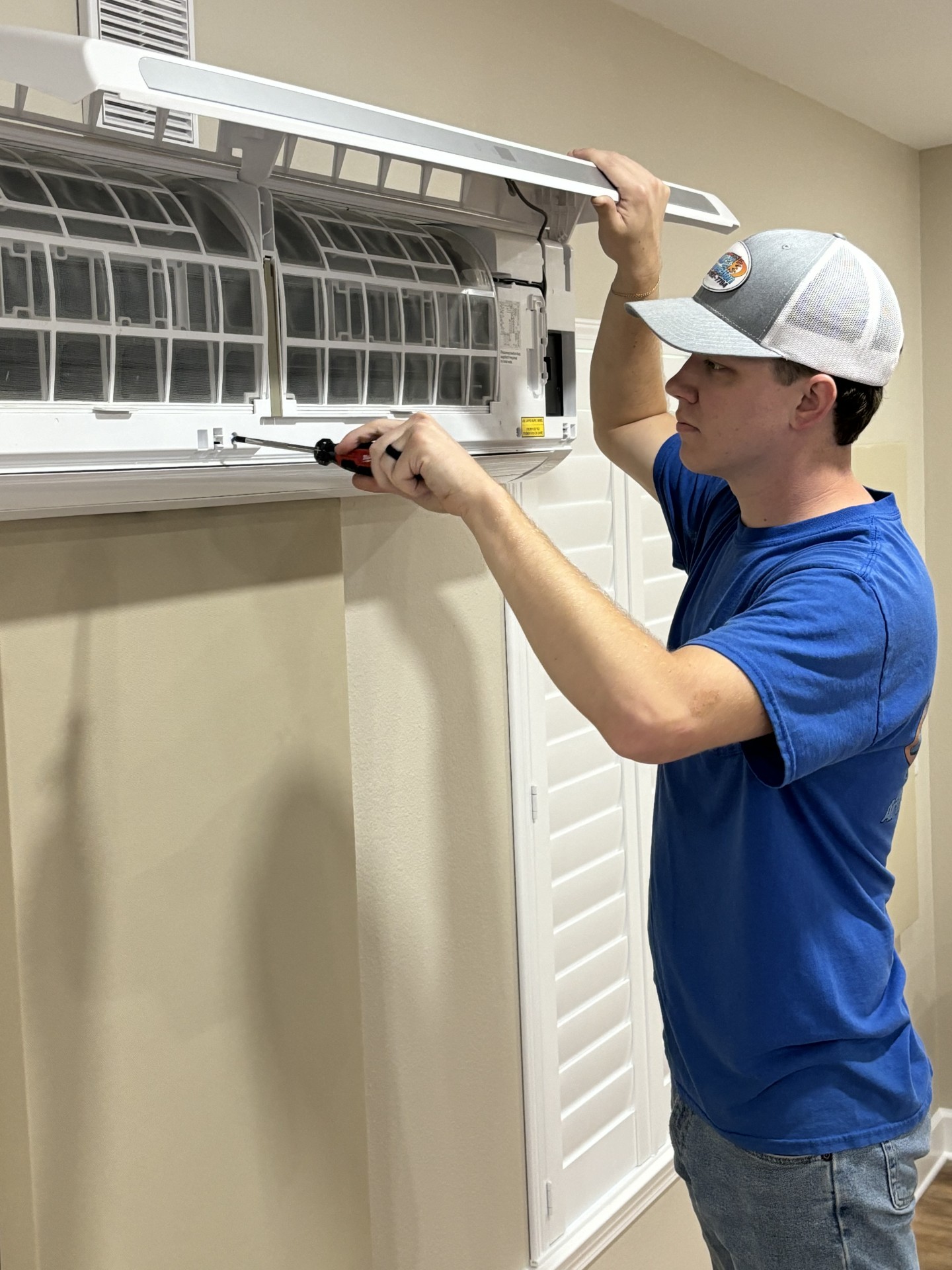 A/C Connection technician servicing HVAC equipment in Pensacola